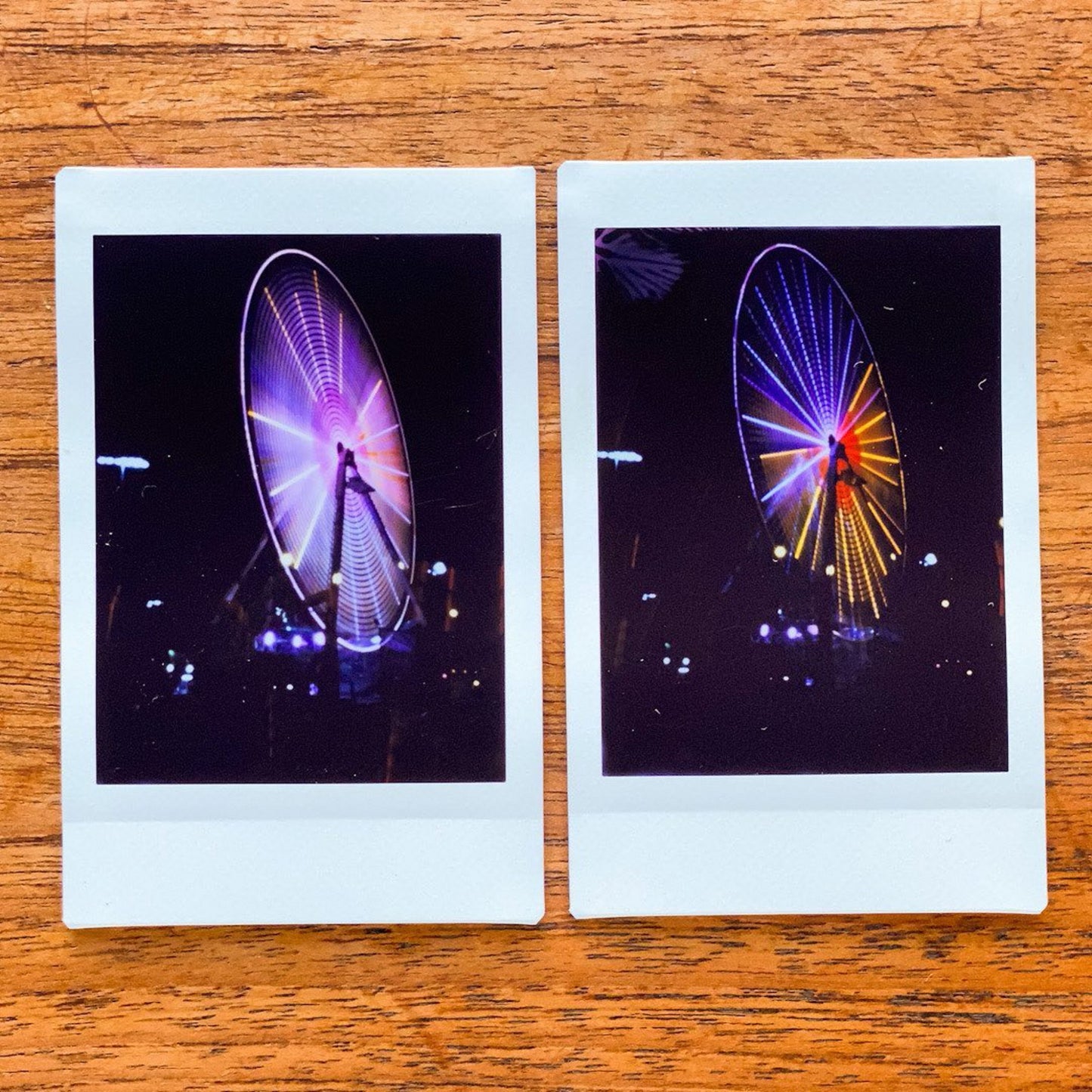 Two instant photos taken with a Jollylook Pinhole Mini camera, positioned on a table, highlighting the rustic and nostalgic charm of a Wagon Wheel
