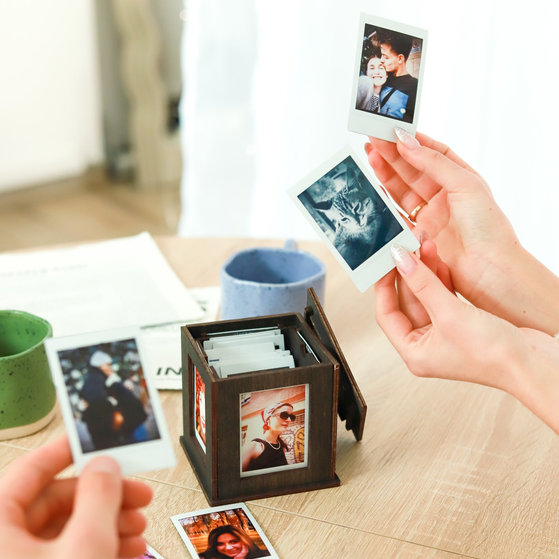 Jollylook Photo Box on a table with Instax Mini photos