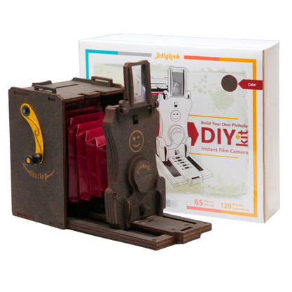 Image featuring the Pre-assembled Pinhole Instant Mini Film Camera in its Stained Brown color, positioned on a white background. Adjacent or nearby, the packaging is adorned with the Jollylook branding and product details.