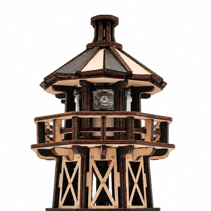 Jollylook Kinetic Lighthouse wooden mechanical model kit assembled and lit on a tabletop. It has a real working light with three modes: warm, cold, and mixed. 