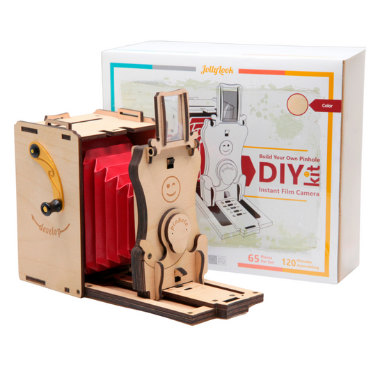 Image featuring the Pre-assembled Pinhole Instant Mini Film Camera in its Natural Wood color, positioned on a white background. Adjacent or nearby, the packaging is adorned with the Jollylook branding and product details.