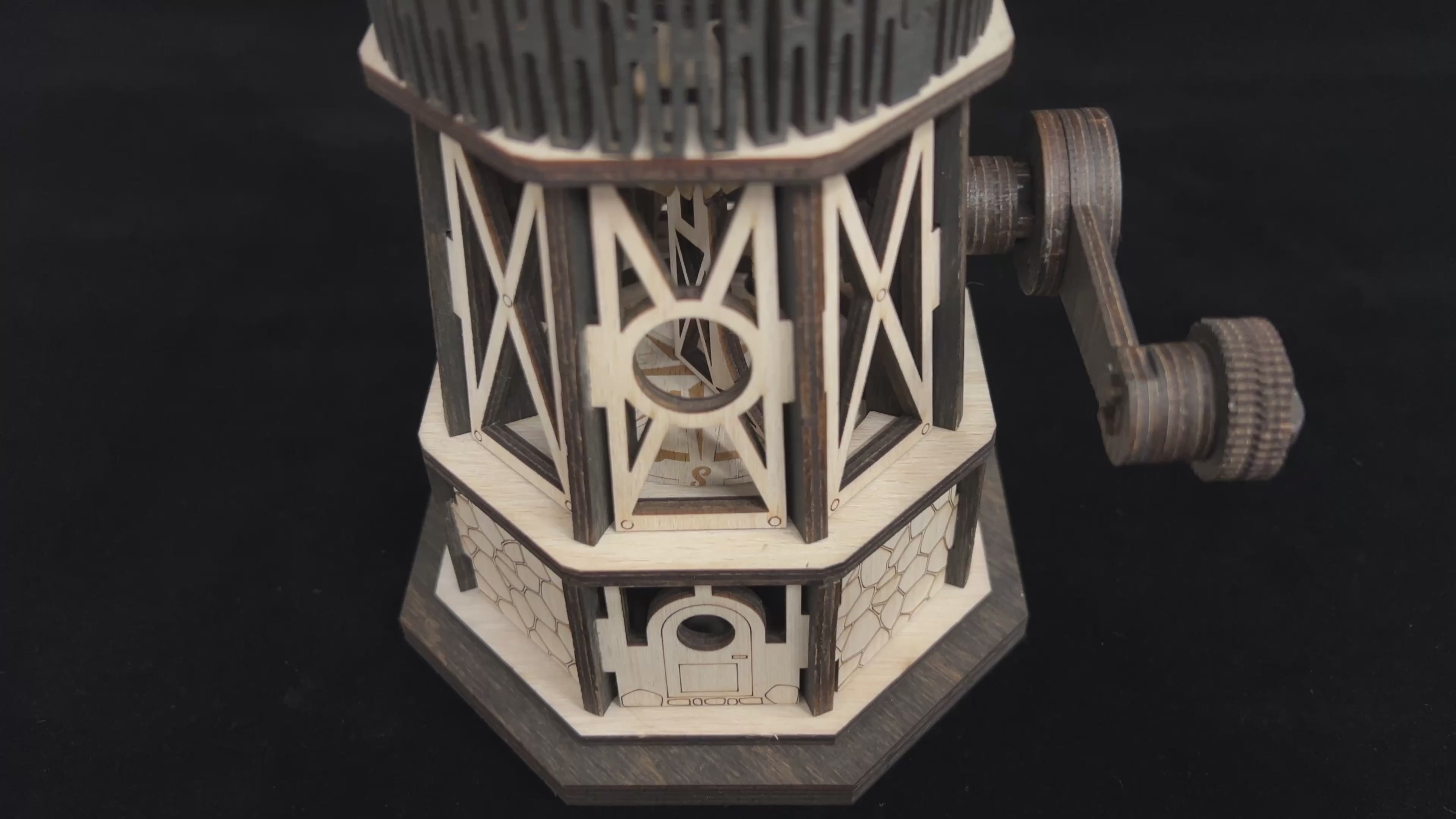 Load video: Jollylook Kinetic Lighthouse wooden mechanical model kit assembled and lit on a tabletop.
Hand-cranked rotating light mechanism inside The Kinetic Lighthouse.
Laser-cut beech plywood parts included in The Kinetic Lighthouse DIY kit